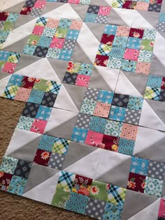 an image of a patchwork quilt on the floor with text overlay that says, i