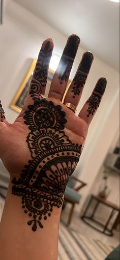 a woman's hand with henna on it