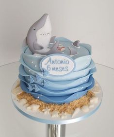 there is a cake made to look like a dolphin on top of the ocean waves