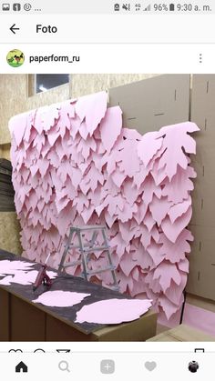 a room with pink paper on the wall and a ladder in front of it that is being worked on