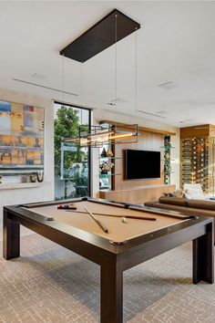 a pool table in the middle of a living room