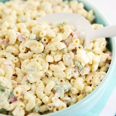 a bowl filled with macaroni salad and a spoon