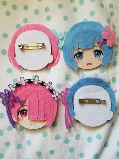 three different hair clips with anime characters on them, one is pink and the other is blue