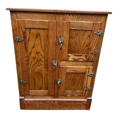 a wooden cabinet with metal handles and knobs on the doors is isolated against a white background