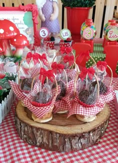 a table topped with lots of candy and candies on top of a wooden slice