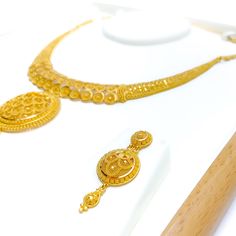 This Fancy Mesh Floral 22k Gold Necklace Set, weighing 56.0 grams, is a remarkable blend of intricacy and elegance. Adorned with a yellow gold finish, it features a delicate mesh floral design, offering a luxurious and sophisticated appearance. The necklace is 17 inches long with a 2.75-inch drop, and it includes 0.8-inch adjustable links for a custom fit. A secure hook lock ensures comfort and ease of wear. The set is completed with matching earrings, each 1.75 inches in length, featuring screw Formal 22k Gold Temple Necklace With Filigree, Gold Temple Necklace With Elegant Design For Formal Occasions, Ceremonial 22k Gold Bridal Necklace With Filigree, Formal Gold Temple Necklace With Elegant Design, Formal Gold Temple Necklace With Filigree, Formal Yellow Gold Filigree Temple Necklace, Gold Bridal Necklace With Intricate Design For Formal Occasions, 22k Yellow Gold Bridal Necklace With Filigree, Formal Gold Bridal Necklace With Intricate Design