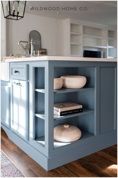 the kitchen island is painted blue and has books on it