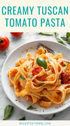 creamy tuscani tomato pasta on a white plate with basil leaves and tomatoes in the background