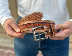 1-1/2" Wide (38 millimeters wide) Handcrafted from genuine leather by our craftsmen, this belt in a Western Cowboy-style gives the authenticity and charm your style has been looking for. The belt comes with a buckle, however the snap-on technique allows you to customize the look of the belt with your own buckle of preference. Simply open up the snap-on buttons to install your buckle. Adjustable Artisan Leather Belt Buckles, Adjustable Hand-tooled Leather Belt, Artisan Handmade Leather Belt Buckles, Handmade Artisan Leather Belt Buckles, Adjustable Western Belt Buckles For Everyday Use, Handmade Adjustable Leather Belt Buckles, Southwestern Hand Tooled Leather Belt, Southwestern Style Hand Tooled Leather Belt, Adjustable Embroidered Brown Belt