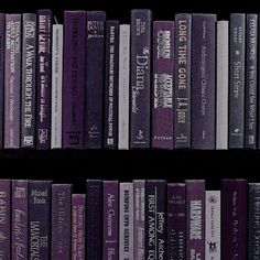 a row of purple books on a black shelf