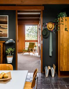 a room with black walls and wooden furniture