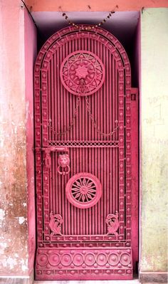 a pink door with intricate designs on it