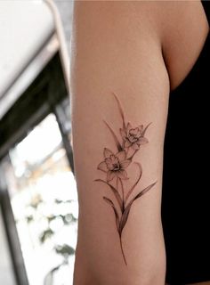 a woman with a tattoo on her arm has flowers in the shape of a heart