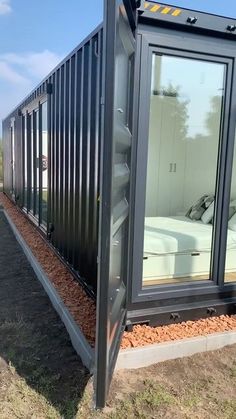 a shipping container that has been converted into a bed in the middle of it's side