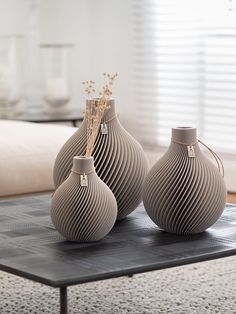 three vases sitting on top of a coffee table