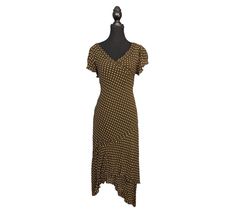 Step into timeless elegance with this vintage polka dot midi dress, crafted from a luxurious silk-like fabric. Featuring a flattering wrap-style V-neck, short flutter sleeves, and a unique asymmetrical hemline, this dress embodies classic charm and flowy movement.  - Vintage polka dot design - Lightweight and breathable silk-like material - Asymmetrical hemline for added flair - Wrap-style V-neck and flutter sleeves Measurements (laid flat): - Armpit to Armpit: 17" (34" bust) - Waist: 15" (30" w Brown Silk V-neck Midi Dress, 90s Polka Dot Dress, 90s Fashion Aesthetic, Brown V-neck Midi Dress With Buttons, Retro V-neck Polka Dot Dress, Retro Polka Dot V-neck Dress, Dress Asymmetrical, Brown Polka Dots, Fall Dress