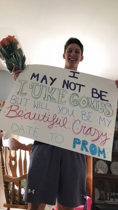 a man holding up a sign that says i may not be sorry to my wife, but will you be my beautiful crazy date to prom