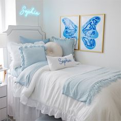 a bedroom with blue and white decor on the walls