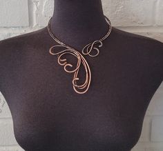 Handcrafted antique copper open necklace with bare copper wire. Hammered, tarnished, polished, and covered with a clear coating to protect the necklace from future discoloration.  If you need to clean your copper jewelry, please clean it by using warm water, and soap. Simply rub the mixture lightly and rinse with clean water and dry with a soft cloth.  Only one available. The pictured jewelry item in this listing is the actual piece you will receive. There are no Photoshop enhancements.  Thank you very much for looking! Happy shopping! Adjustable Bronze Copper Necklace, Artistic Copper Jewelry With Soldered Details, Unique Rose Gold Metal Necklace, Artistic Brown Copper Jewelry, Adjustable Hand Forged Copper Necklace, Hand Forged Copper Wire Necklace With Adjustable Fit, Hand Forged Rose Gold Copper Necklace, Hand Forged Copper Necklace In Rose Gold, Soldered Copper Rose Gold Necklace