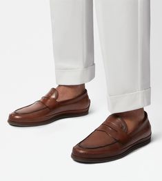 Characterized by a rubber pebble outsole and an elegant woven piping, these loafers are crafted in calfskin leather. Featuring a classic penny bar and the stamped Tod's monogram, they interpret a refined urban taste. Brown Loafers, Monogrammed Leather, Loafers Men, Calf Skin, Penny, Dust Bag, Universe, Loafers, Monogram