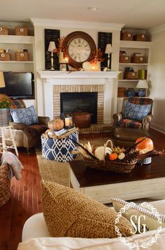 a living room filled with furniture and a clock on the wall above a fire place