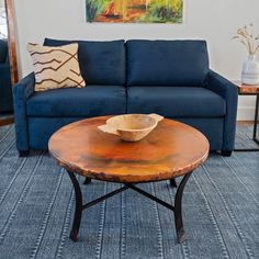 a living room with a blue couch and coffee table