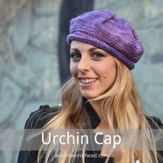 a woman with long blonde hair wearing a purple knitted hat and smiling at the camera