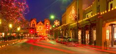 the city street is lit up with christmas lights