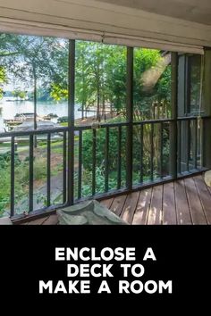 an enclosed porch with wooden flooring and glass doors leading to a large deck that overlooks a lake