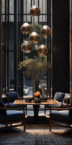 an elegant dining room with blue chairs and gold globes hanging from the ceiling above