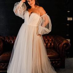 a woman in a white dress posing for the camera