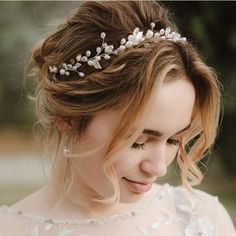 a woman wearing a tiara with flowers on her head