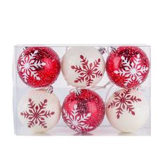 six red and white snowflake ornaments in a clear box on a white background