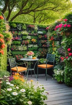 an outdoor patio with flowers on the wall and chairs in the foreground, surrounded by greenery