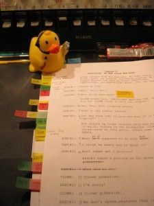 a rubber ducky sitting on top of a piece of paper next to a keyboard