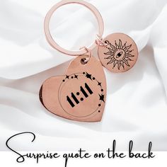 a heart shaped keychain with the words surprise gate on it's back