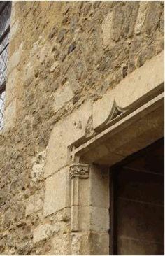 an old stone building with a door and window