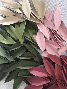 several different colored paper leaves laying on top of each other in the shape of flowers