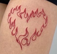 a woman's thigh with red flames drawn on it and the shape of a heart