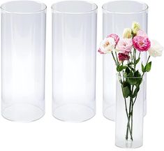 three clear vases with pink and white flowers in each one, on a white background