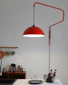 a red lamp hanging over a kitchen counter