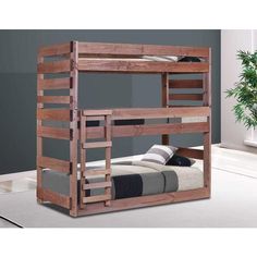 a wooden bunk bed sitting on top of a white floor next to a potted plant