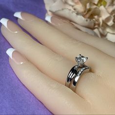 a woman's hand with two wedding rings on it