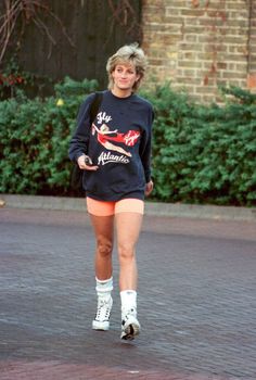 a woman rollerblading down the street in short shorts