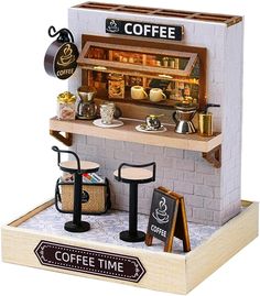 a miniature coffee shop with two stools and a sign that says coffee time on it