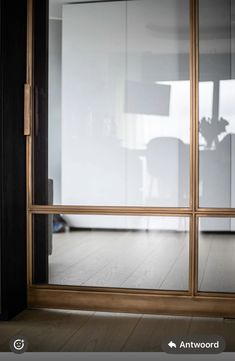 an empty room with wooden floors and sliding glass doors