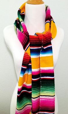 I've turned a traditional Mexican serape into a warm, comfy Mexican scarf.Made from an authentic Mexican serape, each scarf wrap is 78 inches long and 9 inches wide. Each end is finished with 3.5 inch long fringe.It can be wrapped around your neck several times for added warmth. It can be draped across your shoulders, tied at your throat or held in place with a simple knot.I finished off the edges with a coordinating thread in a zigzag pattern. Bohemian Multicolor One Size Wraps, Bohemian Multicolor One-size Wraps, Multicolor Hippie Shawl One Size, Multicolor One-size Hippie Shawl, Hippie Multicolor One-size Shawl, Multicolor One Size Hippie Shawl, Traditional Multicolor Scarves For Winter, Traditional Multicolor Winter Scarves, Traditional Multicolor Winter Scarf