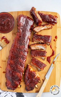 bbq ribs and barbecue sauce on a cutting board