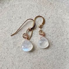 Our simple dainty moonstone drop earrings are a classic pair and the perfect lightweight everyday earring. The genuine moonstone gemstones are striking and make a minimalist statement. Because of their simple style, they are the perfect pair to complement a necklace. They would make a beautiful personalized gift as we offer a choice of every month's birthstone as well as other popular gemstones in the drop-down menu. Also available in gold filled, sterling silver, rose gold filled and 14k gold. The model is wearing the moonstone June birthstone earrings in 14k gold filled. CRAFTSMANSHIP  Jewelry is handmade by us in our NYC studio. We focus on craftsmanship and quality using only the highest quality materials and handpicked genuine gemstones.  PACKAGING We take pride in creating beautifull Everyday Nickel Free Moonstone Jewelry, Everyday Moonstone Gemstone Earrings, Adjustable Teardrop Moonstone Earrings, Minimalist Nickel Free Moonstone Earrings, Elegant Crystal Earrings With Moon Charm As Gift, Round Moonstone Earrings, Minimalist Nickel-free Moonstone Earrings, Everyday Round Moonstone Earrings, Teardrop Moon Charm Earrings Gift