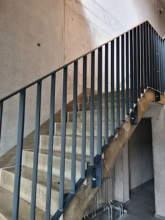 a set of stairs with metal handrails next to a wall